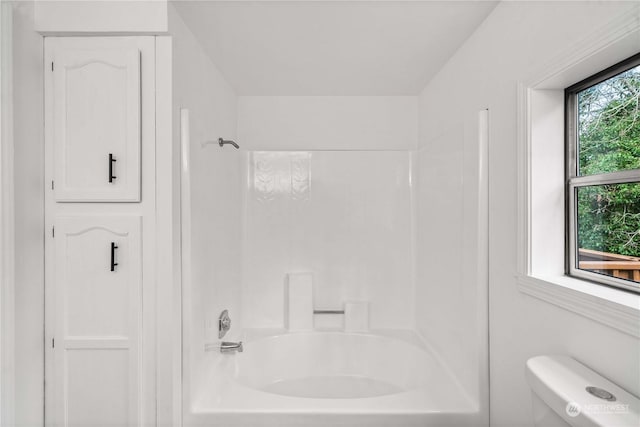 bathroom featuring a healthy amount of sunlight, shower / bathing tub combination, and toilet