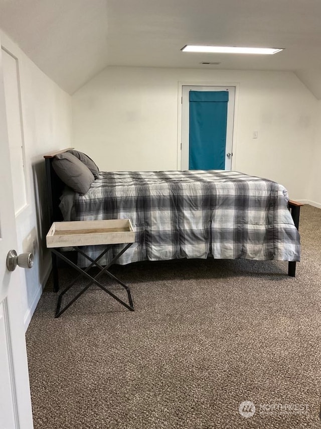 bedroom featuring carpet and vaulted ceiling