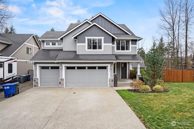 craftsman house with a front yard and a garage