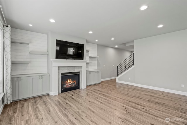 unfurnished living room with light hardwood / wood-style flooring and a fireplace