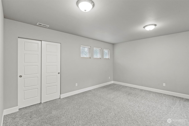 unfurnished bedroom featuring a closet and carpet flooring