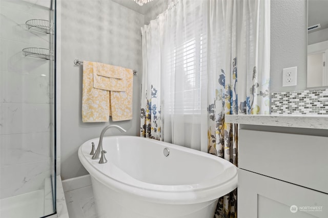 bathroom featuring backsplash and independent shower and bath