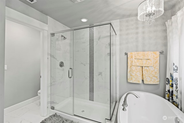 bathroom with toilet, a notable chandelier, and separate shower and tub