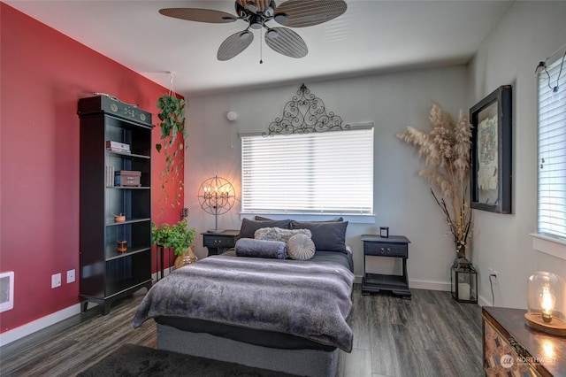 bedroom with ceiling fan and dark wood-type flooring