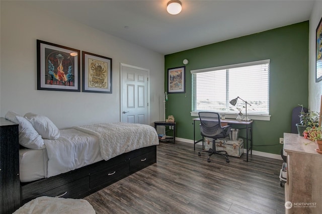 bedroom with dark hardwood / wood-style flooring