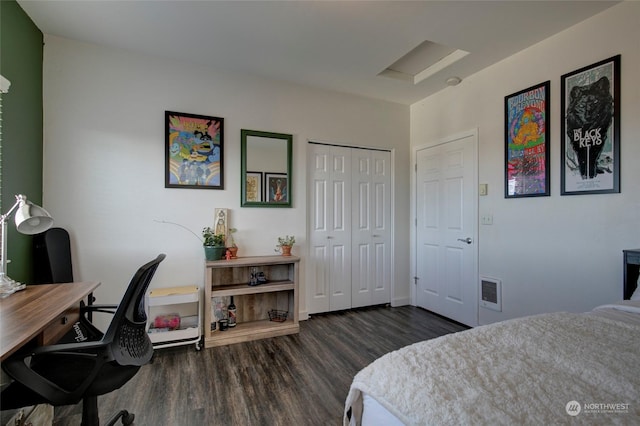 bedroom with dark wood-type flooring and a closet