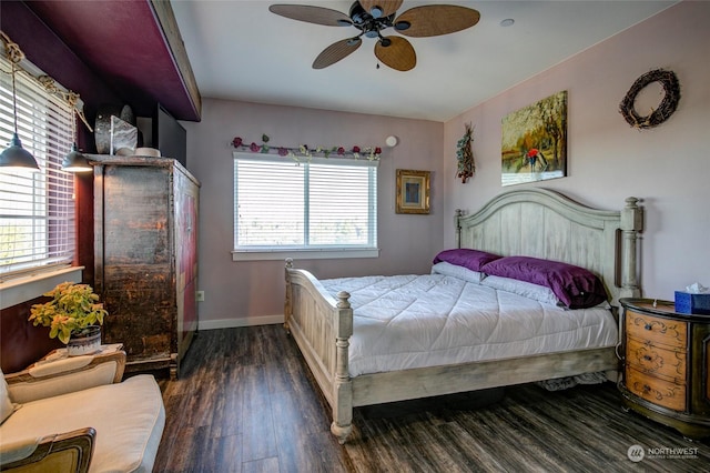 bedroom with ceiling fan, dark hardwood / wood-style flooring, and multiple windows