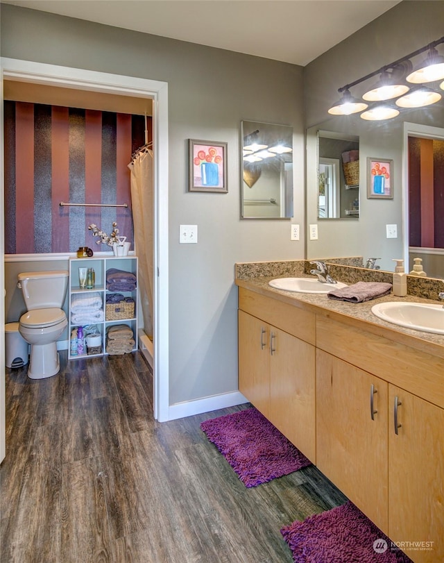 bathroom featuring toilet, a shower with shower curtain, vanity, and hardwood / wood-style flooring