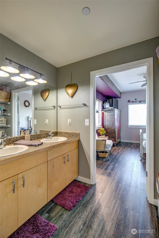 bathroom featuring ceiling fan, vanity, and hardwood / wood-style flooring