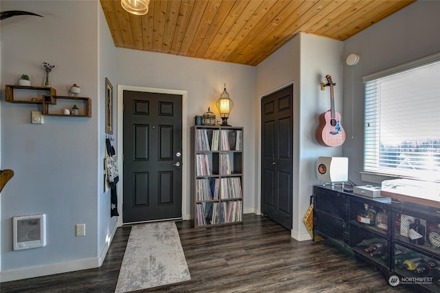 entrance foyer with wood ceiling, dark hardwood / wood-style flooring, and heating unit