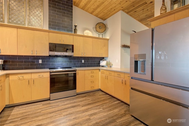 kitchen with wooden ceiling, appliances with stainless steel finishes, light brown cabinetry, high vaulted ceiling, and tasteful backsplash