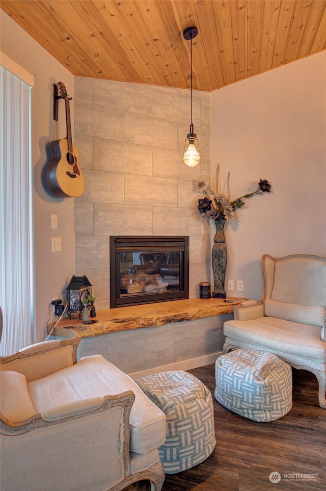 living room with a tile fireplace, hardwood / wood-style flooring, and wood ceiling