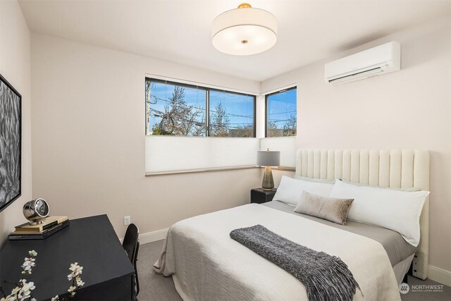 bedroom with carpet floors and a wall mounted air conditioner