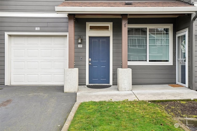 view of exterior entry featuring a garage