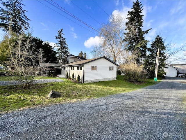 view of side of home featuring a yard