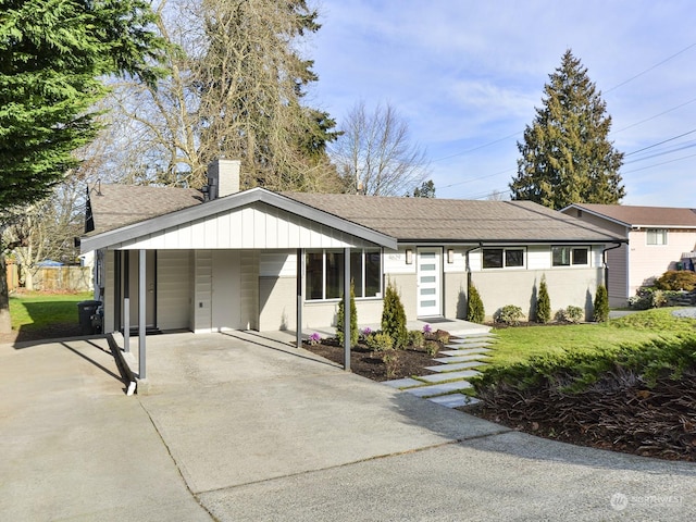 single story home featuring a front yard and a carport