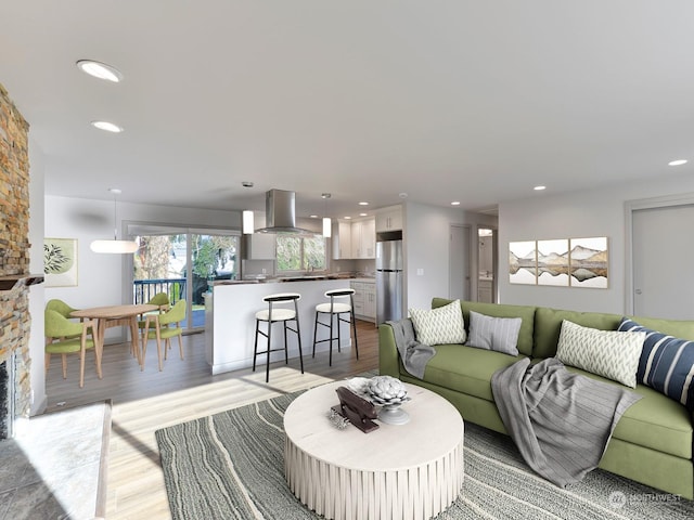 living room featuring a stone fireplace and light wood-type flooring