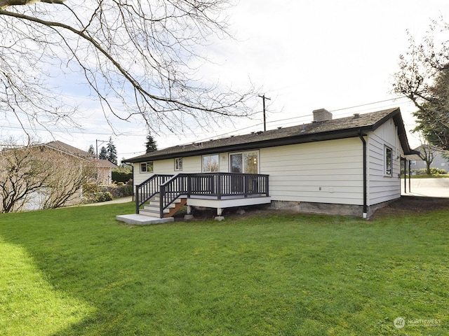 back of house with a yard and a deck