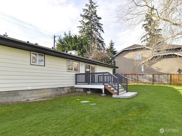 back of house with a yard and a deck