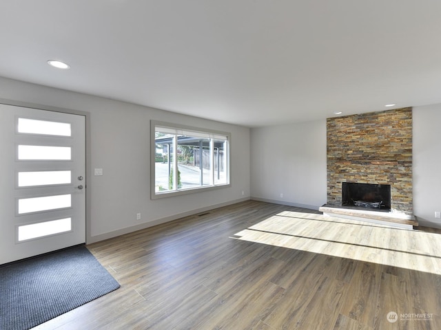 unfurnished living room with hardwood / wood-style flooring and a fireplace