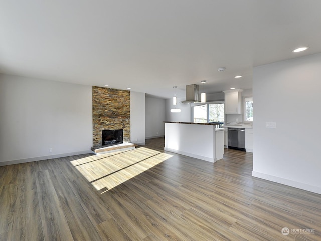 unfurnished living room featuring hardwood / wood-style floors and a fireplace