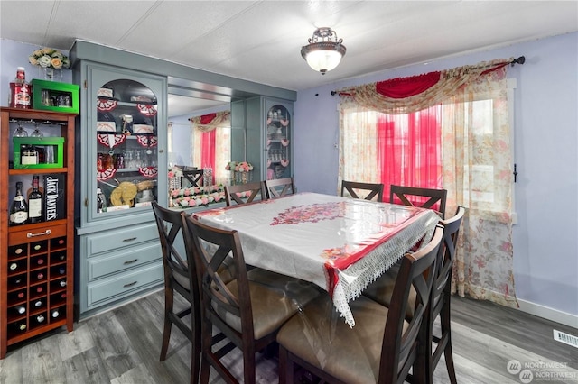 dining space with wood-type flooring