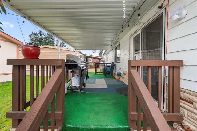 wooden deck featuring a yard and grilling area