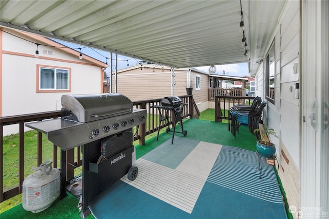 view of patio featuring a storage unit and a grill