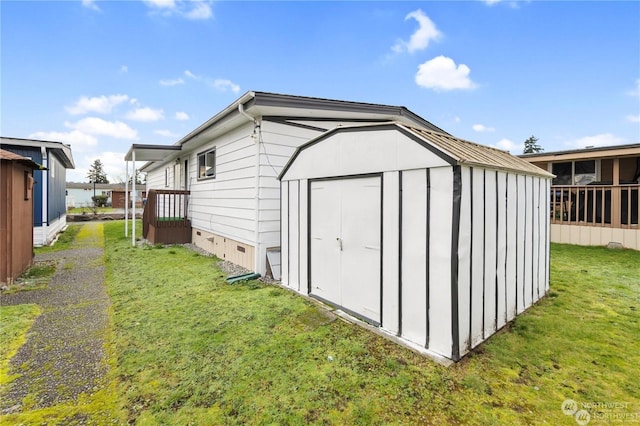 view of outbuilding featuring a lawn