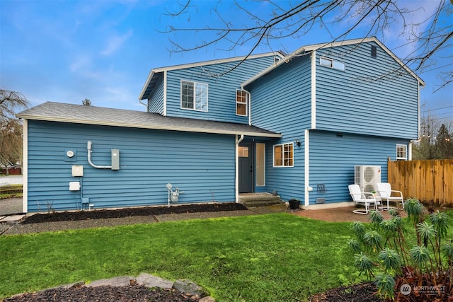 rear view of property with a yard and a patio