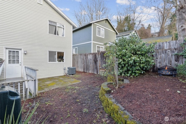 exterior space featuring central AC unit and a fire pit