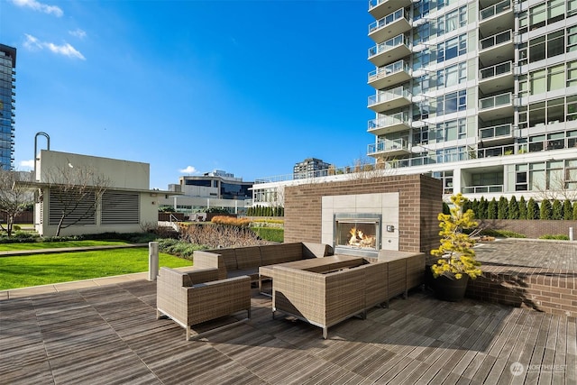 wooden deck featuring an outdoor living space with a fireplace