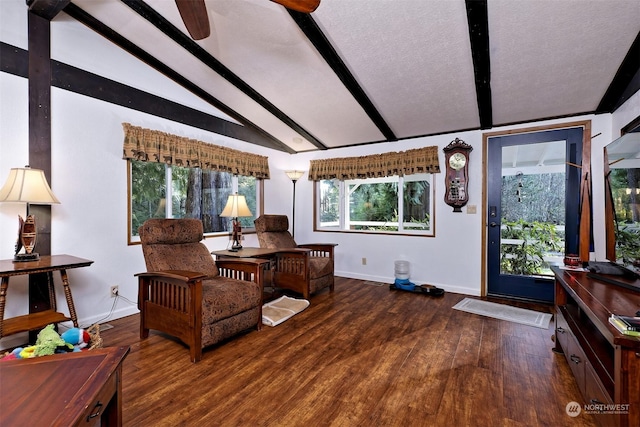 interior space with ceiling fan, vaulted ceiling with beams, a textured ceiling, and dark hardwood / wood-style flooring