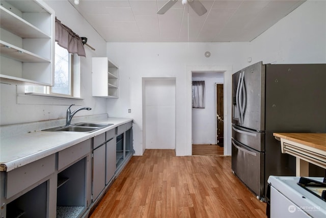 kitchen with ceiling fan, gray cabinets, stainless steel refrigerator with ice dispenser, sink, and light hardwood / wood-style flooring