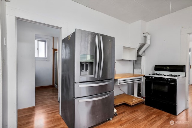 kitchen featuring white cabinetry, gas range oven, stainless steel fridge with ice dispenser, and light hardwood / wood-style flooring