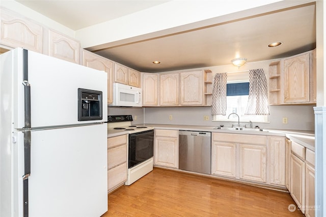 kitchen featuring white appliances, light brown cabinetry, light hardwood / wood-style flooring, and sink