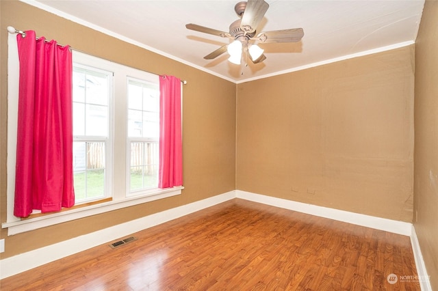 unfurnished room with wood-type flooring, ceiling fan, a healthy amount of sunlight, and crown molding