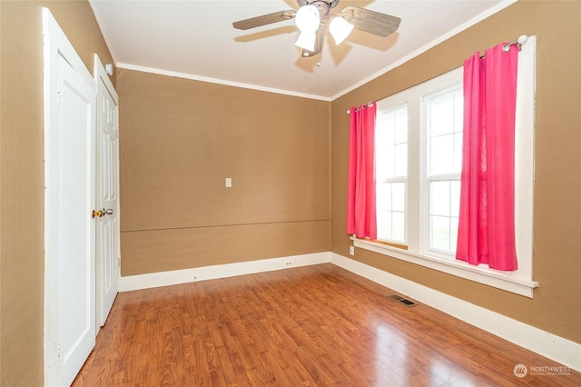 spare room with ceiling fan, wood-type flooring, and plenty of natural light