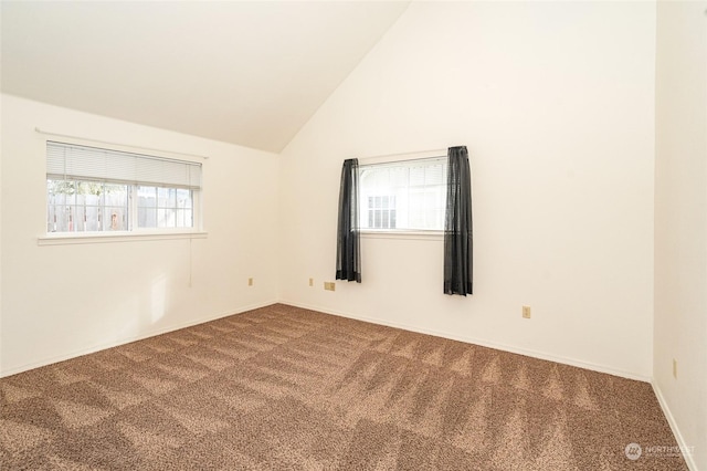 spare room with carpet floors and lofted ceiling