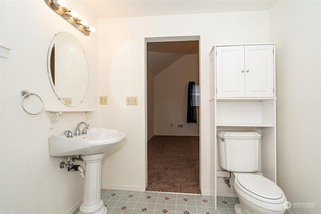 bathroom with toilet, tile patterned flooring, and sink