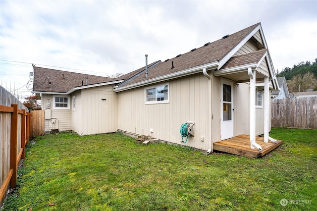 rear view of property featuring a yard