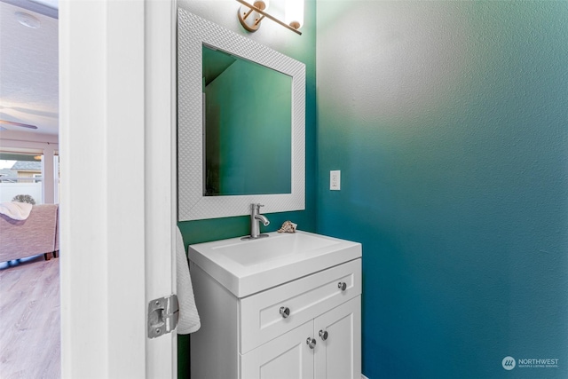 bathroom with ceiling fan and vanity