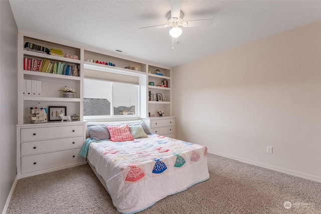 carpeted bedroom with a textured ceiling and ceiling fan