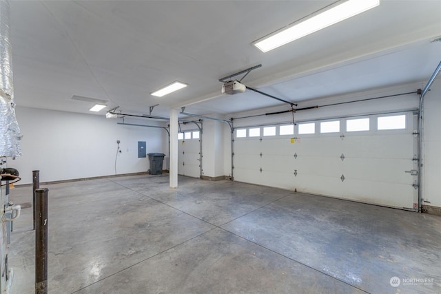 garage with electric panel and a garage door opener