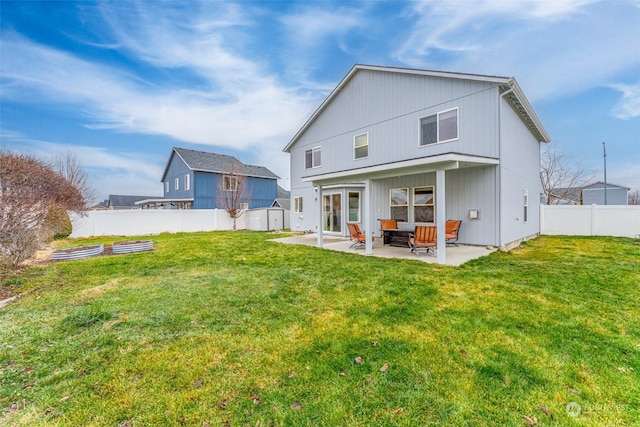 back of house featuring a yard and a patio