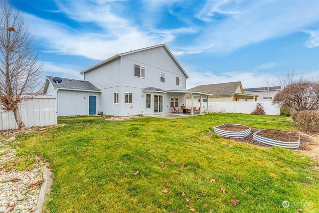 back of house featuring a lawn, a storage unit, and a patio