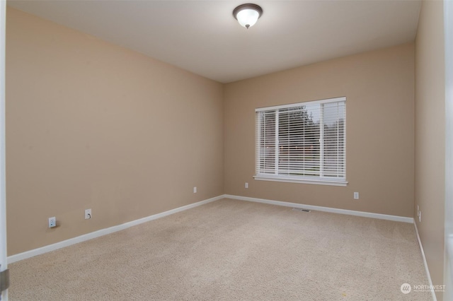 unfurnished room featuring light carpet