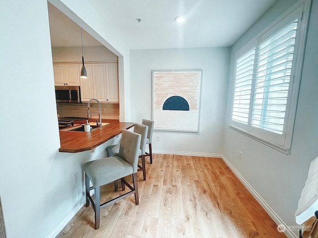 interior space with sink and light hardwood / wood-style floors