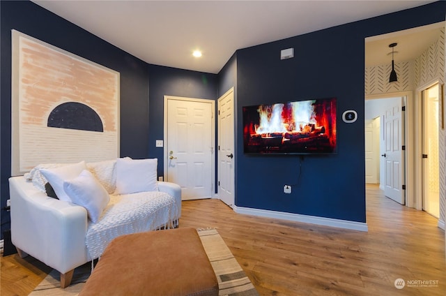 sitting room with wood-type flooring