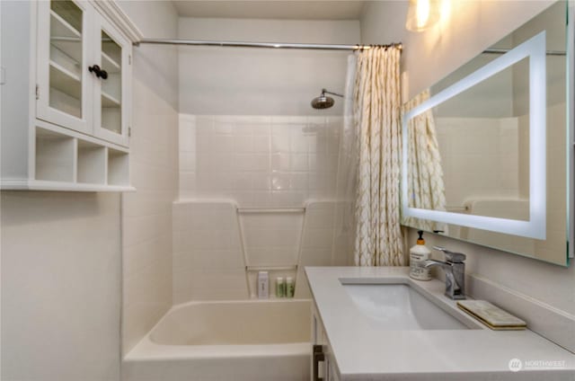 bathroom with shower / tub combo with curtain and vanity